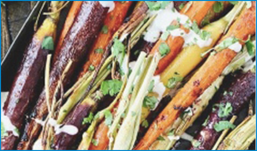 cooked rainbow carrots with chopped cilantro and yogurt sauce